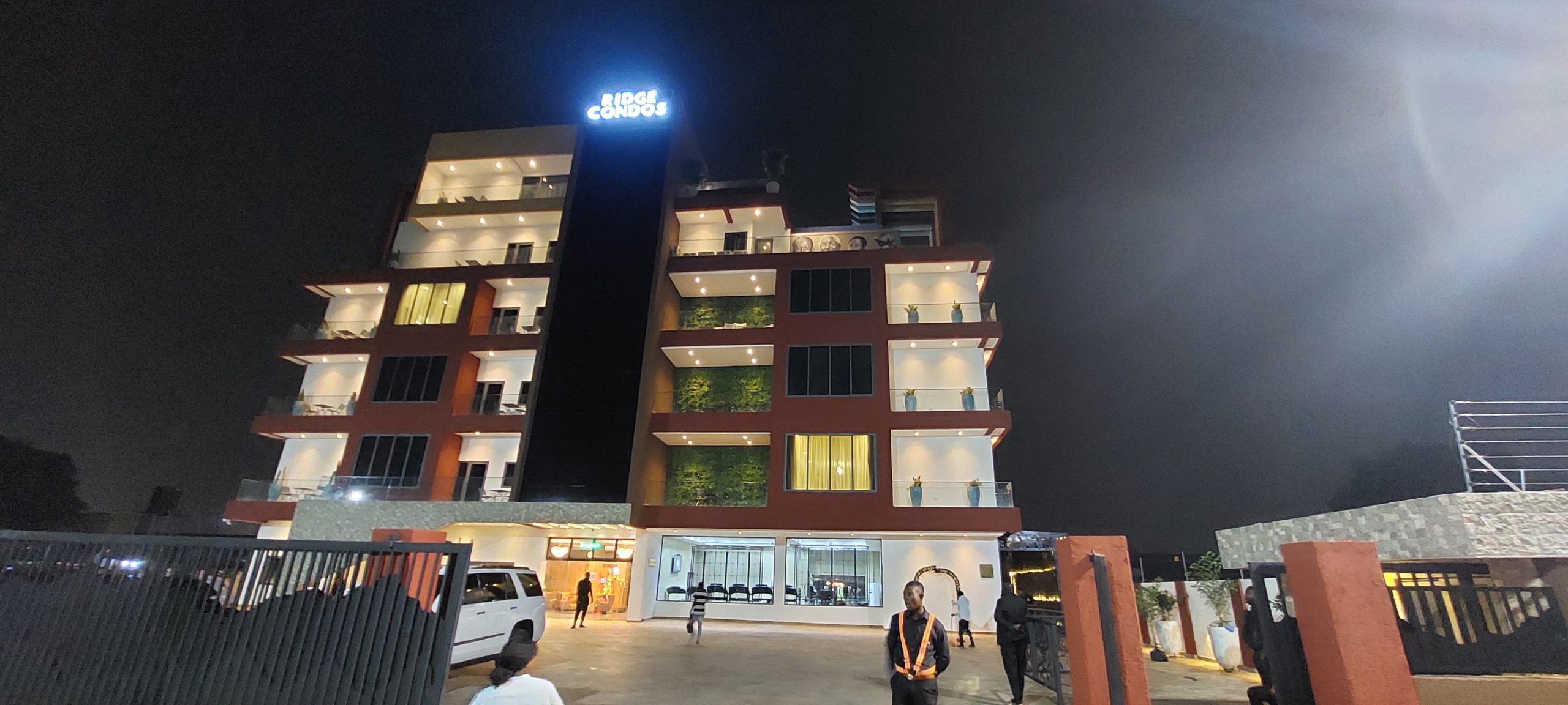 Ridge Condos Hotel lit up at night, Kumasi